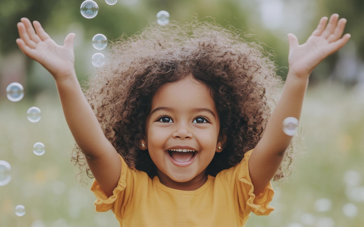 A joyful preschooler playing with bubbles outdoors